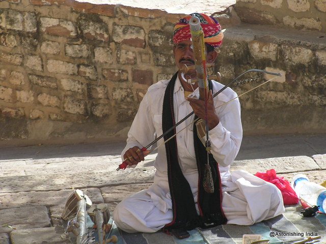 A street artist with local stringed instrument