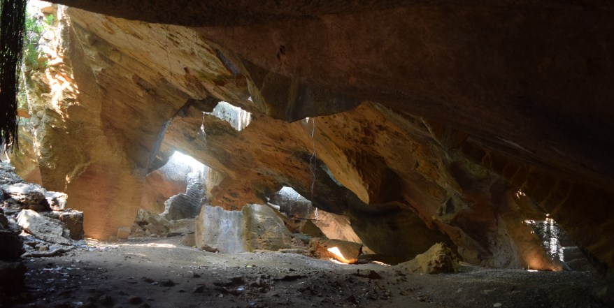 Sunlight filtering in through many gaps in the roof of caves