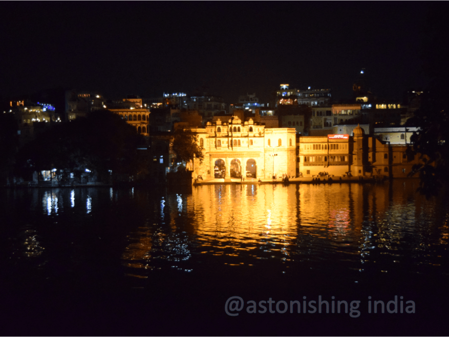 The glittering ghats reflect in the lake