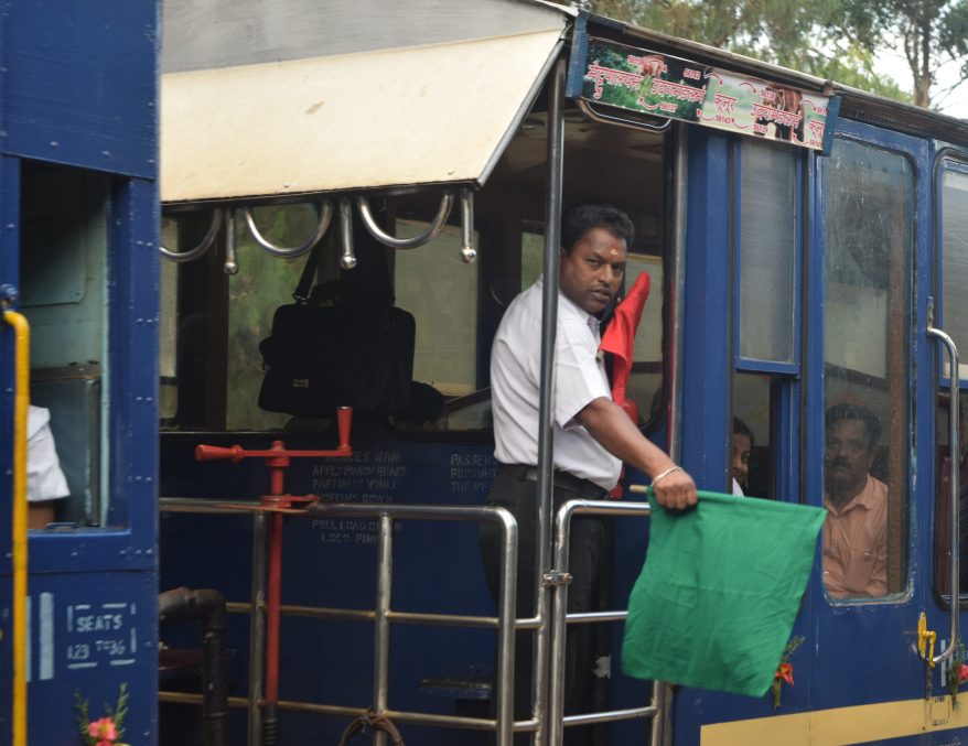 Posing for a picture with green flag