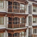 Wood balconies impart a charming warmth to the bland&nbsp;whiteness
