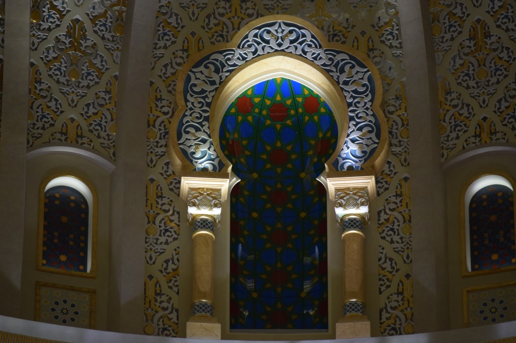 Stained glass panels in traditional projected windows