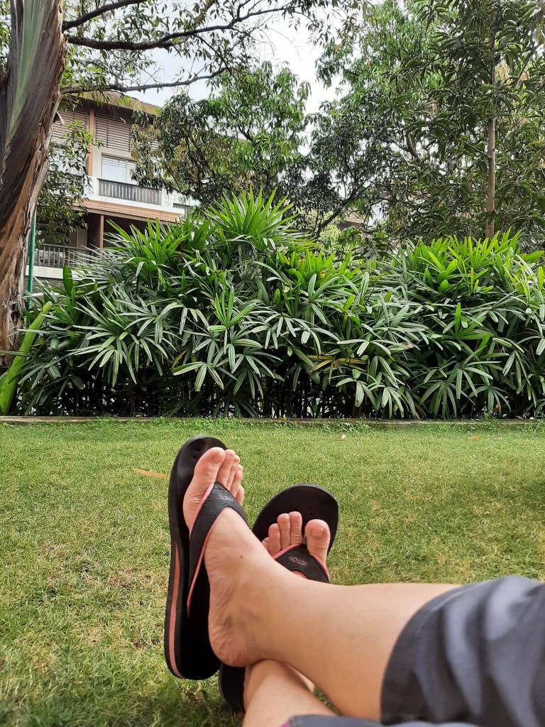 Crossed feet in the lawn